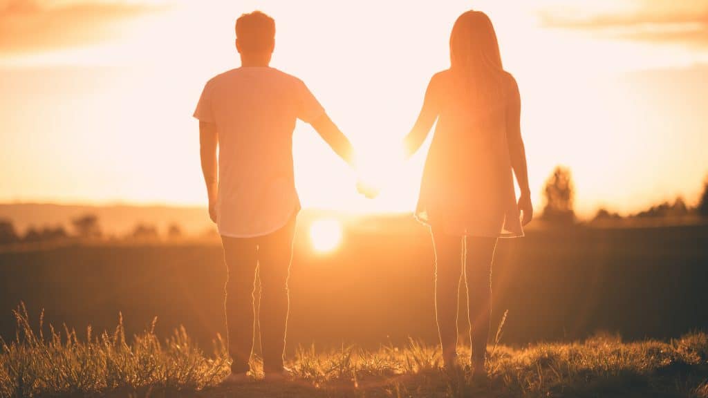 couple in love walk into the sunset